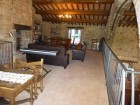 Villa's spacious library with piano, books, fireplace and movie player.